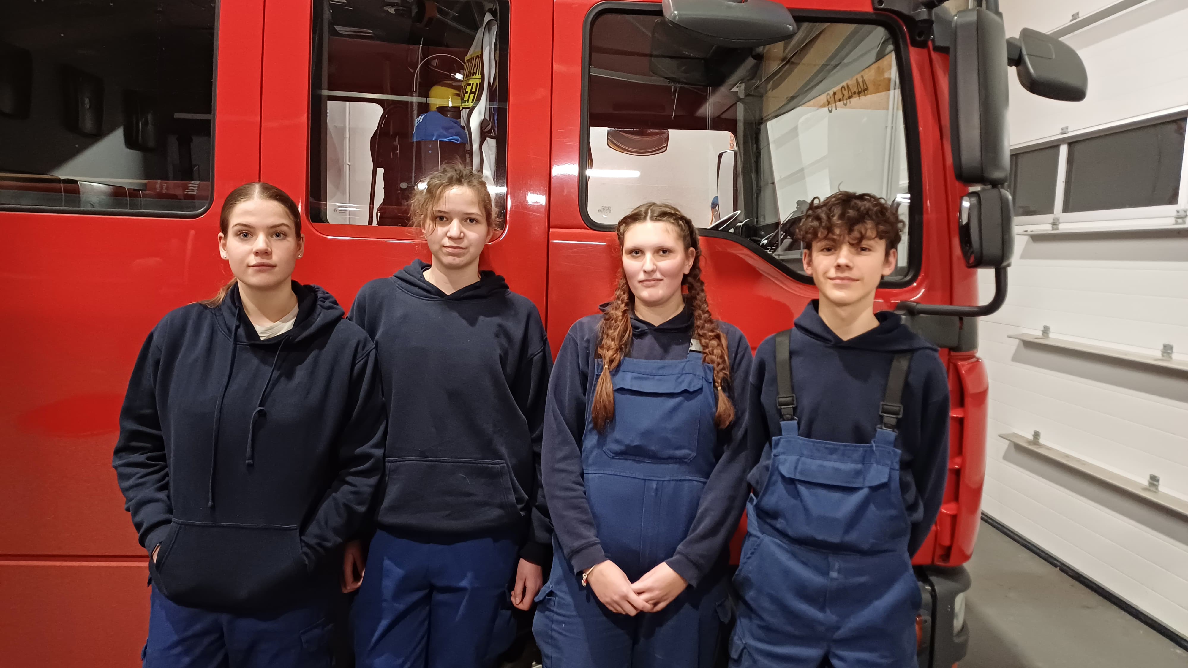 Der neu gewählte Jugendausschuss posiert vor einem Feuerwehrauto